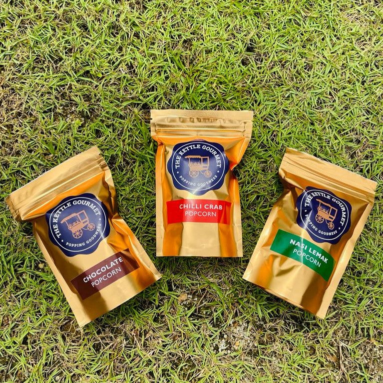 The Kettle Gourmet's mini golden popcorn packaging featuring flavours chocolate, chilli crab and nasi lemak.